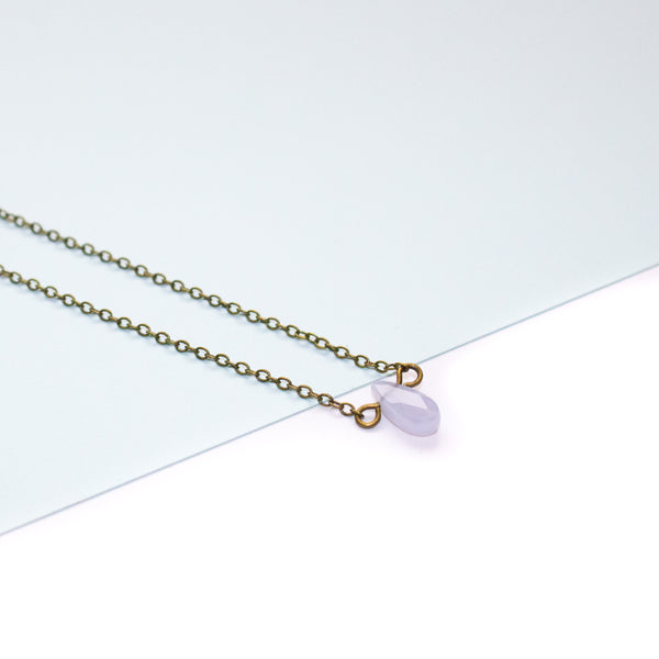 Necklace with a blue lace agate teardrop pendant on a white background