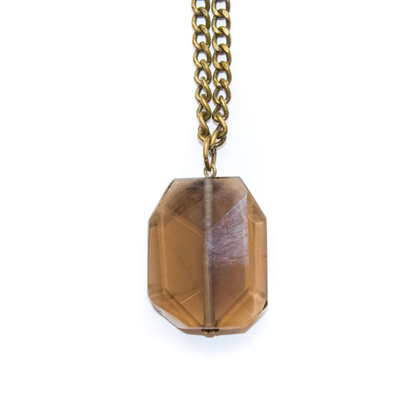 Necklace with a faceted smoky quartz pendant on a white background