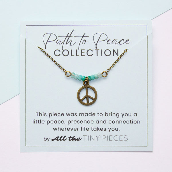 Peace necklace on a card with 'Path to Peace Collection' text