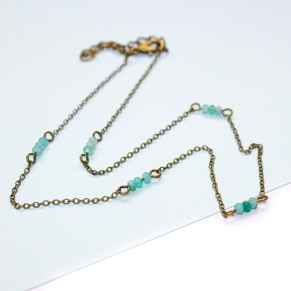 Necklace with amazonite beads and gold chain on a white background