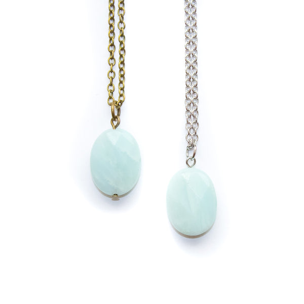 Two necklaces with light blue amazonite pendant beads on a white background