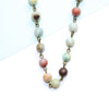 Necklace with multicolored amazonite beads on a white background
