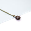 Necklace with a smoky quartz gemstone pendant on a white background