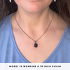 Necklace with a smoky quartz worn by a model, text indicating chain length.