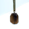 Necklace with a large faceted smoky quartz pendant on a white background