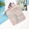 Textile pouch with cactus design on a light blue and white background