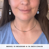 Close-up of a person wearing a necklace with text indicating chain length.