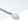 Necklace with a light blue amazonite pendant on a white background