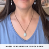 Person wearing an amazonite necklace with an 18-inch chain, shown on a plain background.