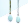 Two necklaces with amazonite stones on a light blue and white background