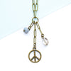 Necklace with peace symbol pendant and beads on a white background